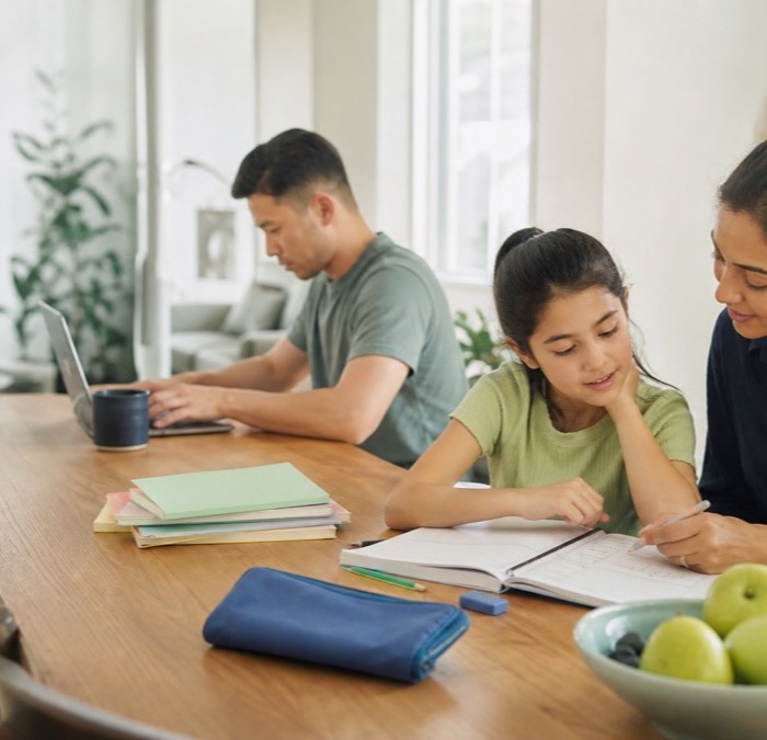 A tutor helping a child with homework at home